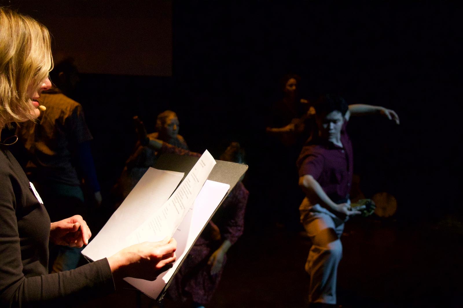 A live scene from Elegies, with Zhenhao Wen dancing in the background
