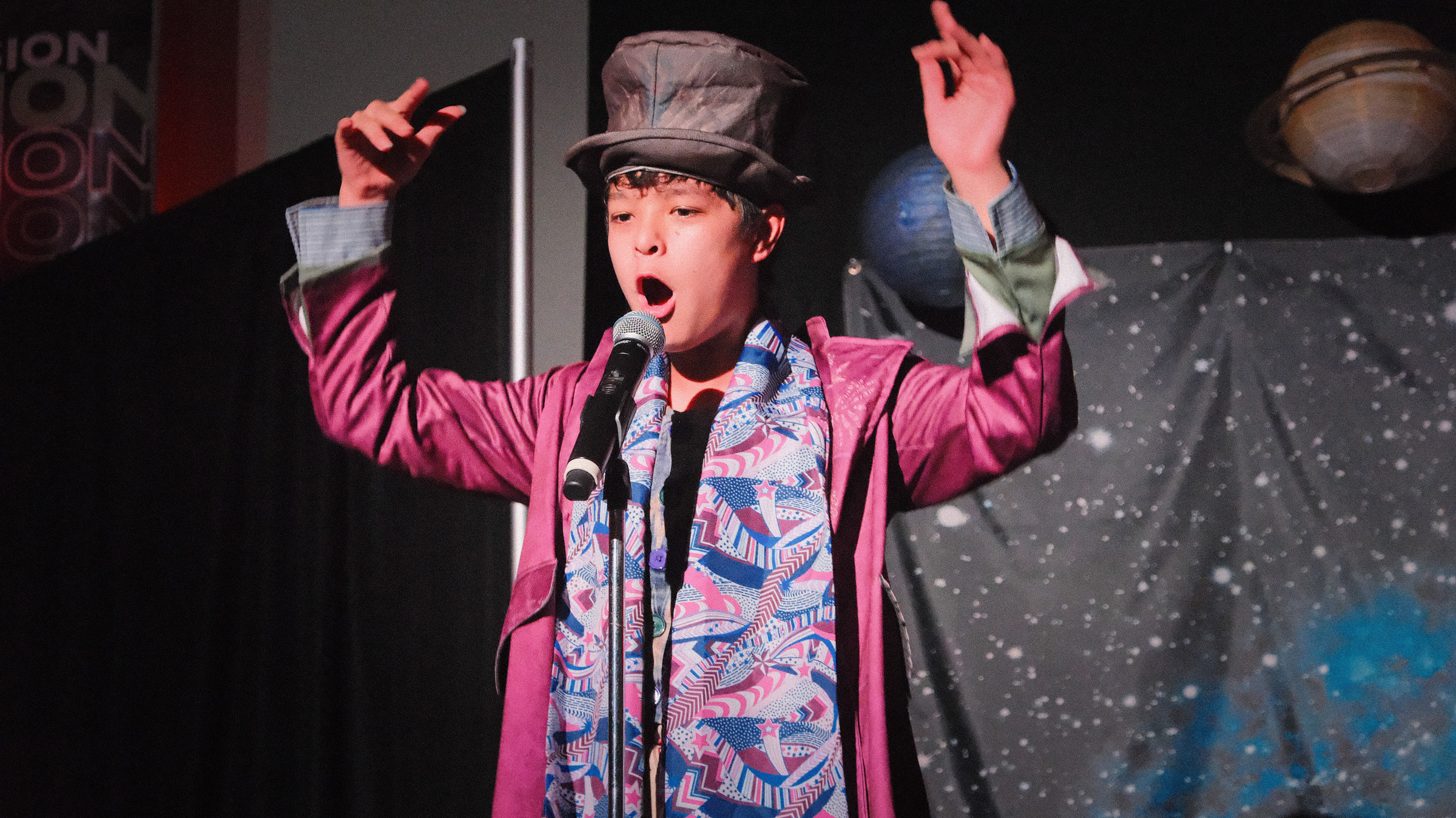 Wonka singing, arms raised