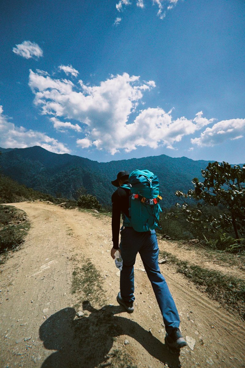 Trekking dirt road under sky