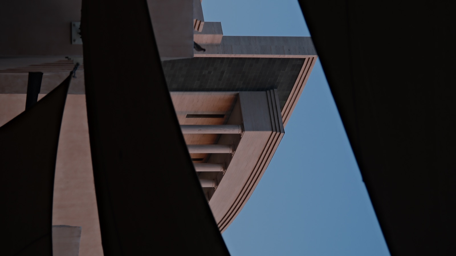 Evening building framed by shade cloth