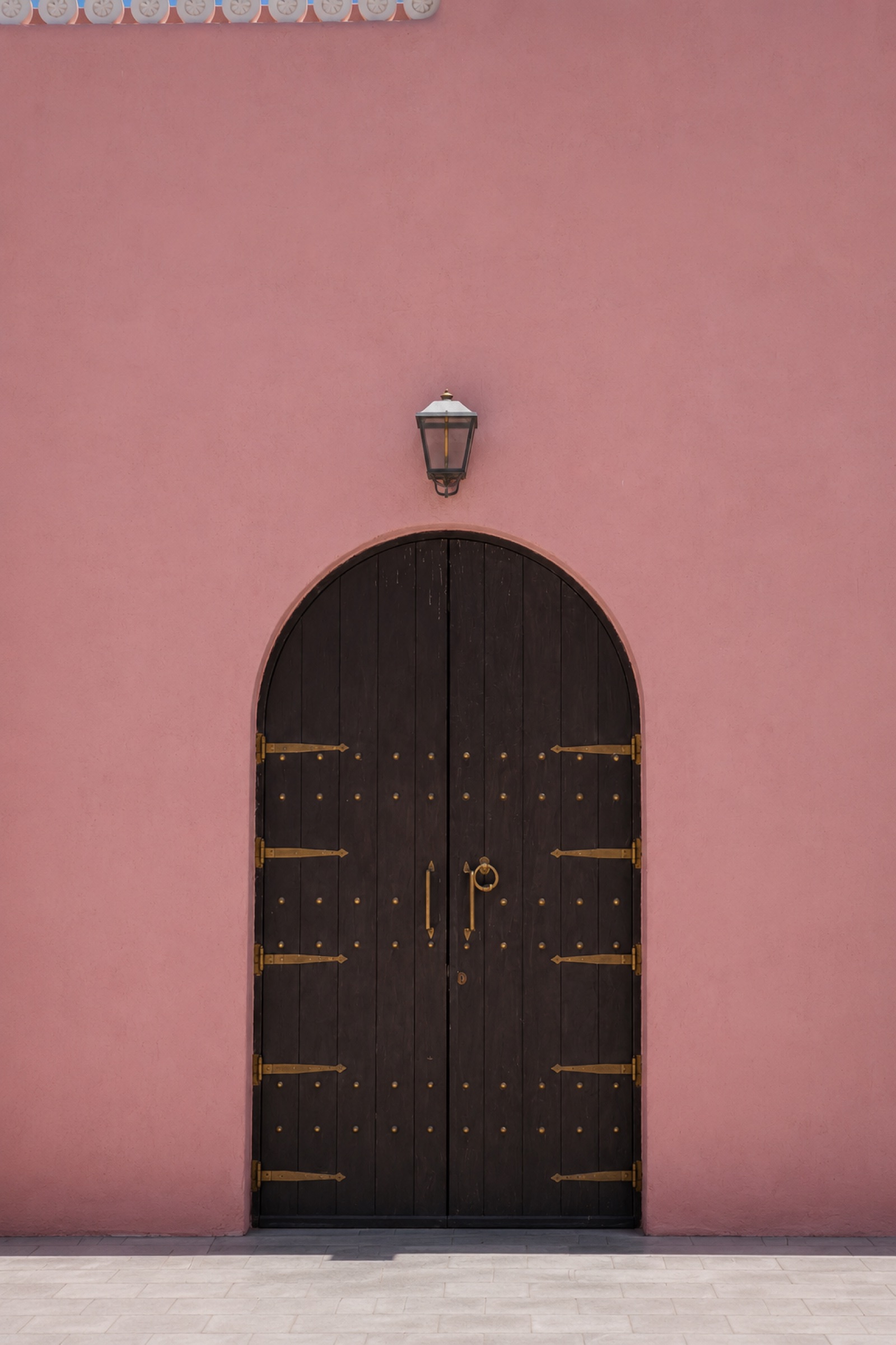 Pink wall and wooden door