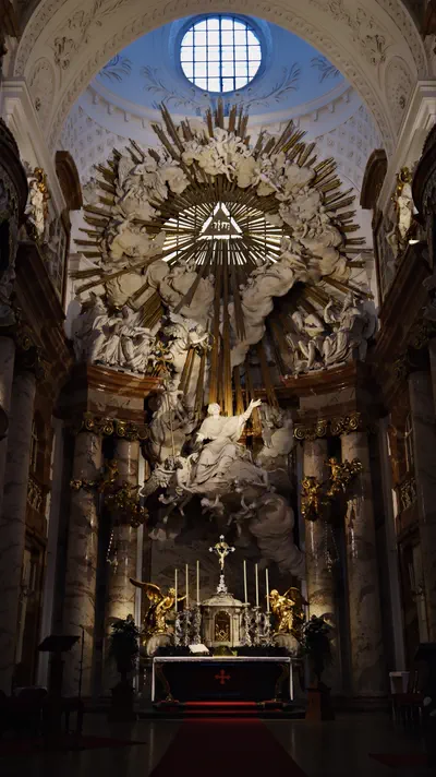 Baroque altar with white figures and gold rays in Vienna, Austria