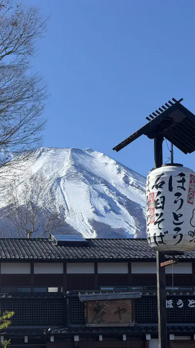 Mount Fuji framed by a Japanese lantern and roofline