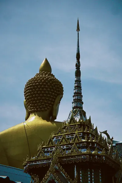 A gilded Buddha and temple spire in Thailand