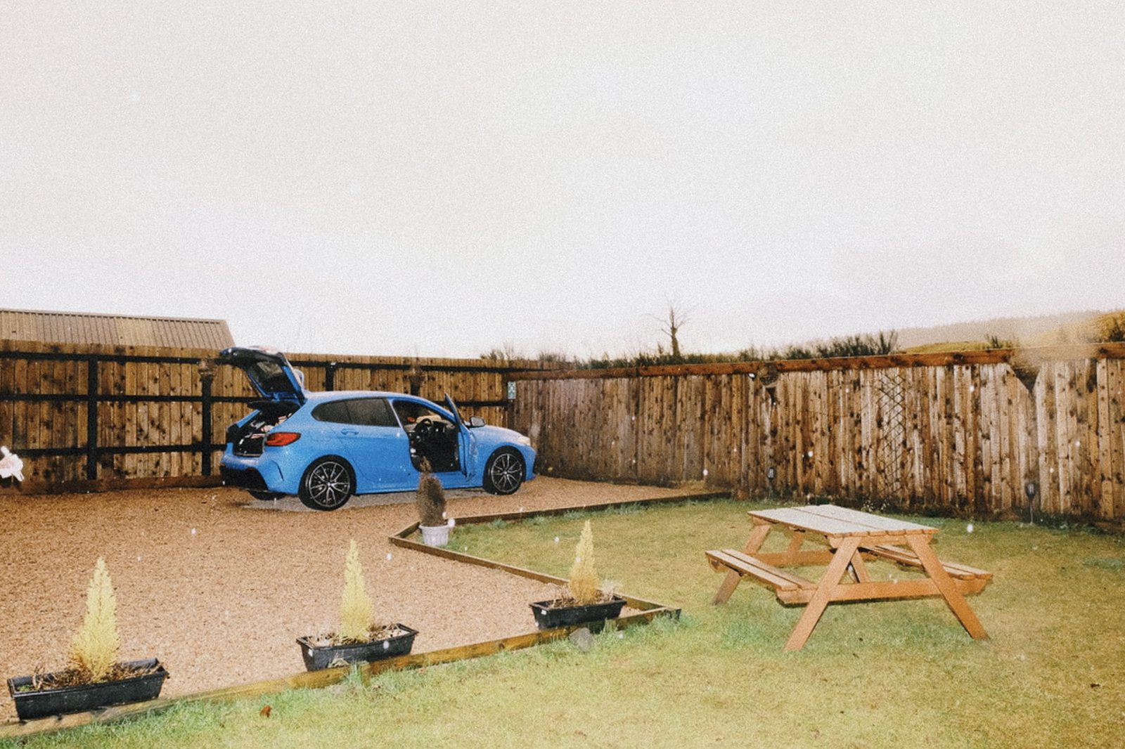 Cottage with blue car