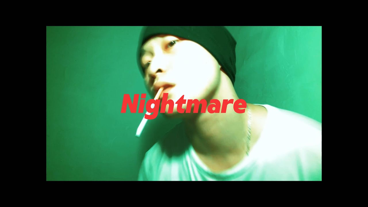 Nightmare poster with a green-tinted close-up of a performer in a black cap